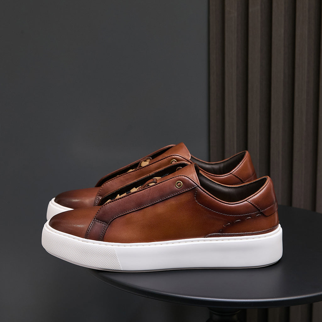 Men's brown leather low-top sneakers with lace-up closure and white sole
