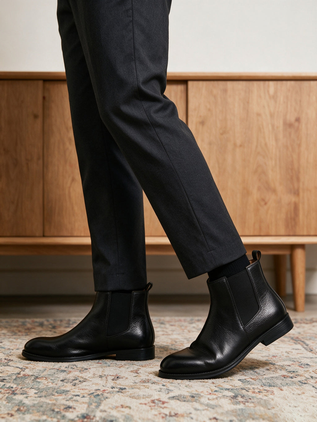 Black Chelsea dress boots with pointed toe, elastic side gore, and low sole