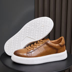 Men's brown leather sneakers shown with outsole side, visible tread and white platform sole
