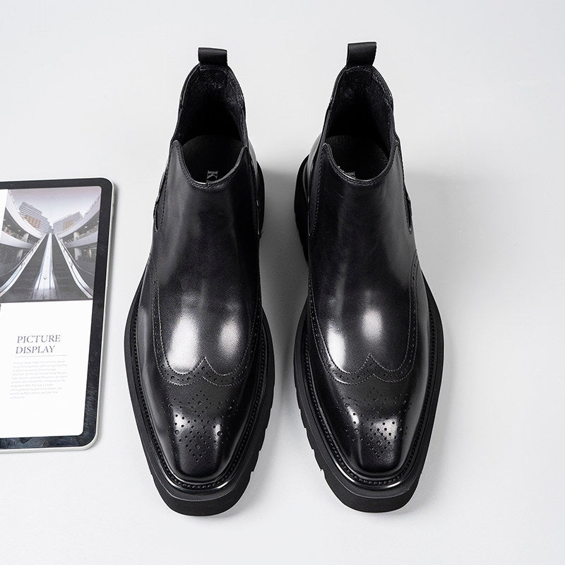 Black leather Chelsea dress boots with perforated toe detail and elastic side gore panels