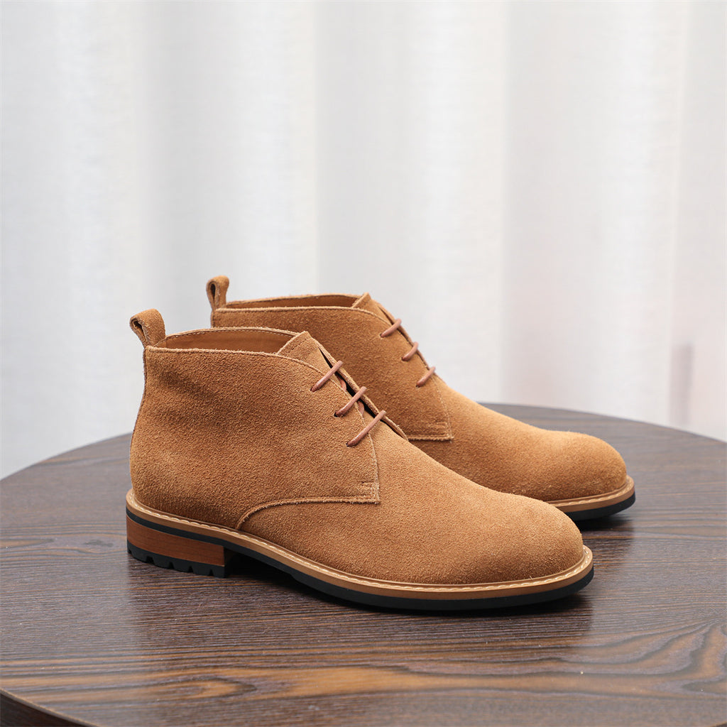 Tan-brown suede lace-up chukka boots with pull tab at the ankle collar.