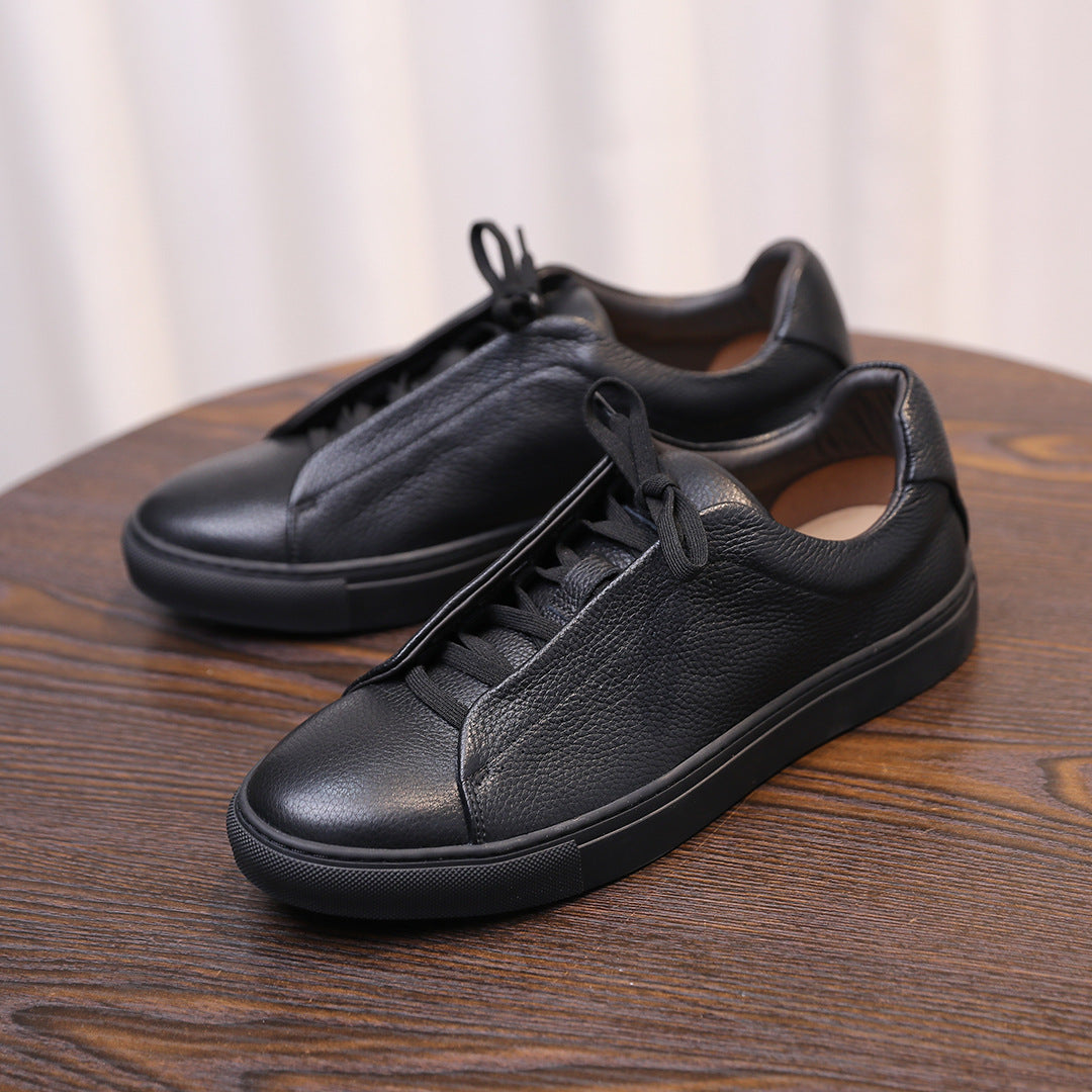 Men's genuine leather sneakers, black pair with lace-up front and stitched leather panels