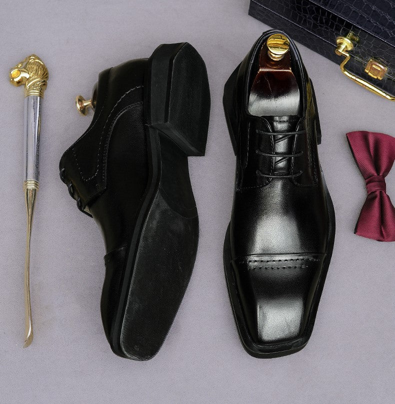 Men's black leather lace-up derby dress shoes, pointed toe with stitched panel detailing.