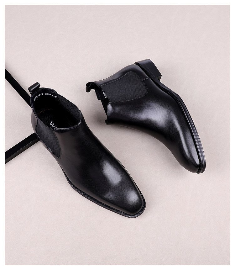 Black leather slip-on Chelsea dress boots with elastic side panels and dark sole