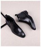 Black leather slip-on Chelsea dress boots with elastic side panels and dark sole