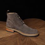 Leather chukka boot in dark brown, plain toe, lace-up design, rubber sole and stacked heel