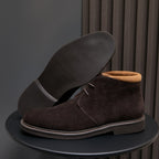 Men's dark brown suede chukka boots with lace-up design and contrast stitching