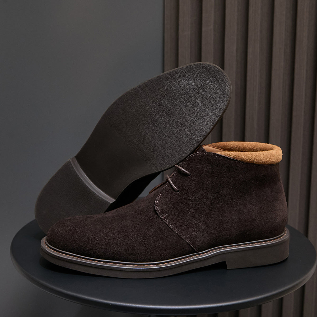 Men's dark brown suede chukka boots with lace-up design and contrast stitching