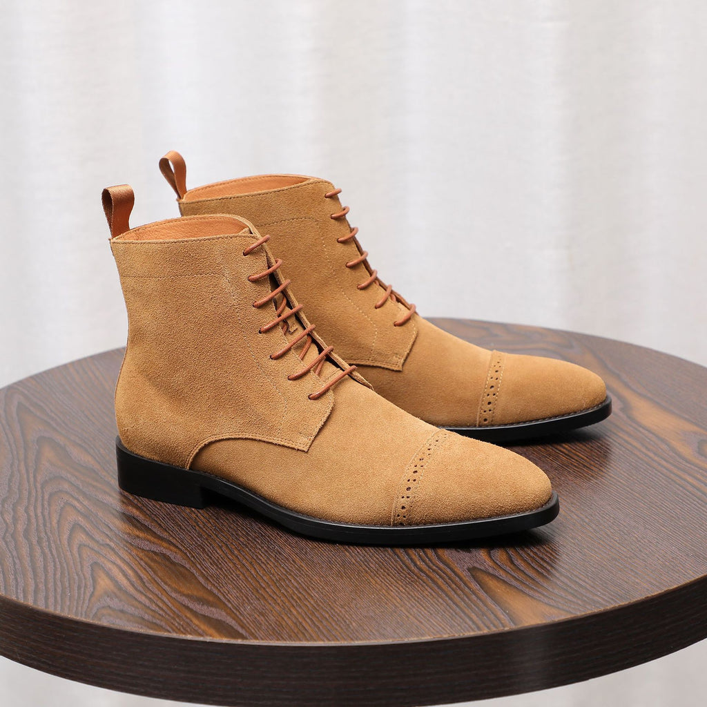 Men's tan suede chukka boots with plain toe, lace-up front, and black rubber sole