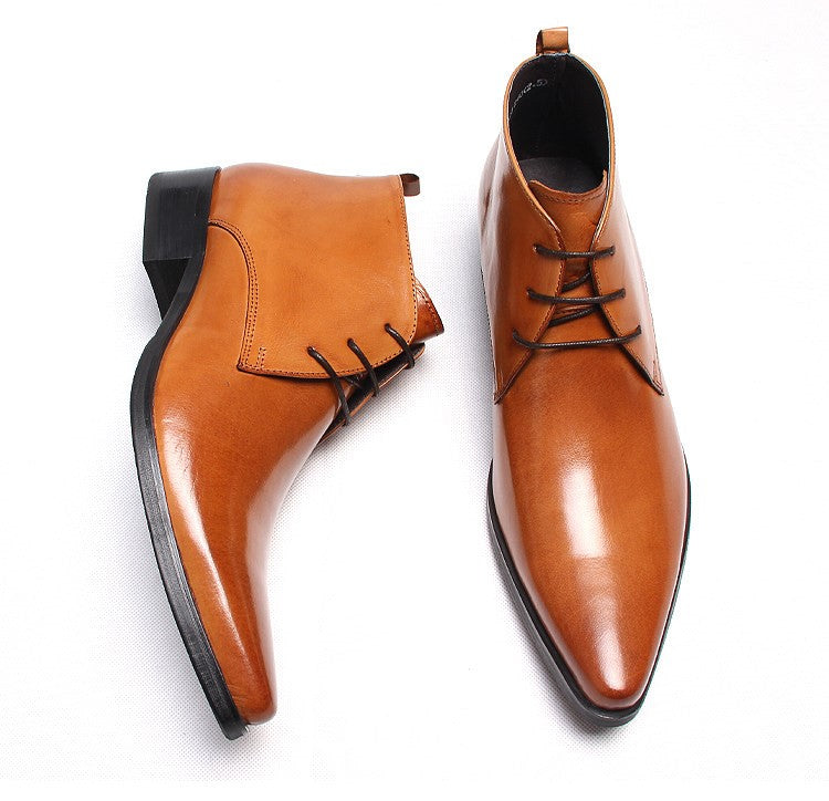 Tan leather lace-up dress boots with pointed toe, stitching details, and low heel.