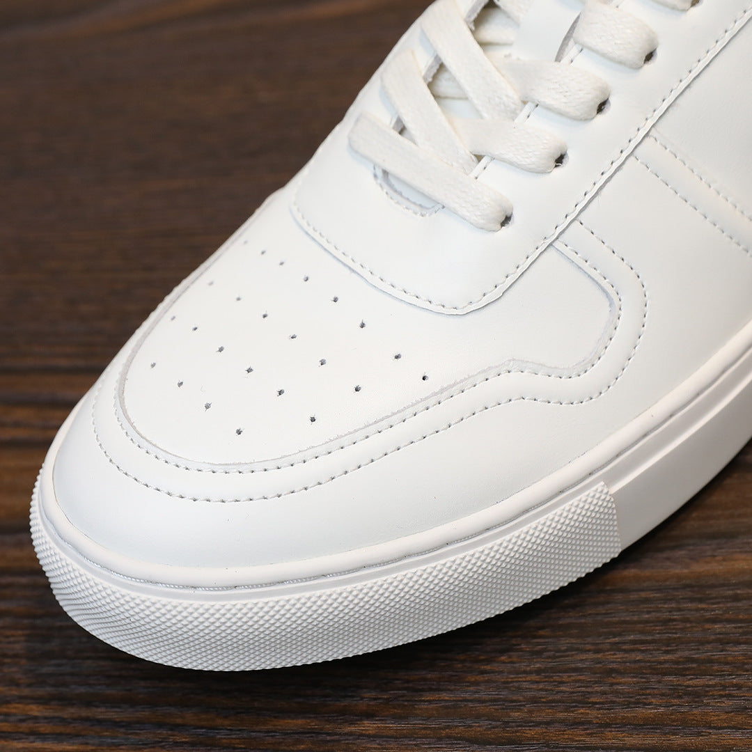 White leather sneaker close-up of lace eyelets and perforated toe