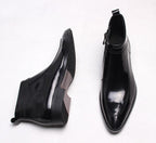 Men's leather side-zip boots with thick sole, black finish, angled view