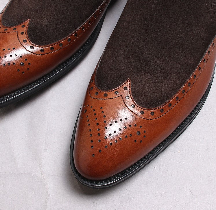 Men's brown leather Chelsea boot with brogue wingtip perforations and dark rubber sole