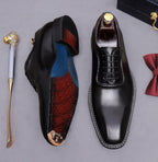 Men's chunky lug sole oxford shoes, black upper with red and blue interior lining detail.