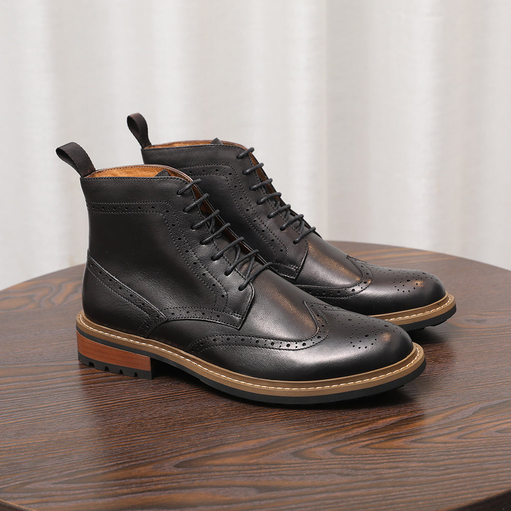 Black leather lace-up chukka boots with perforated toe and thick sole