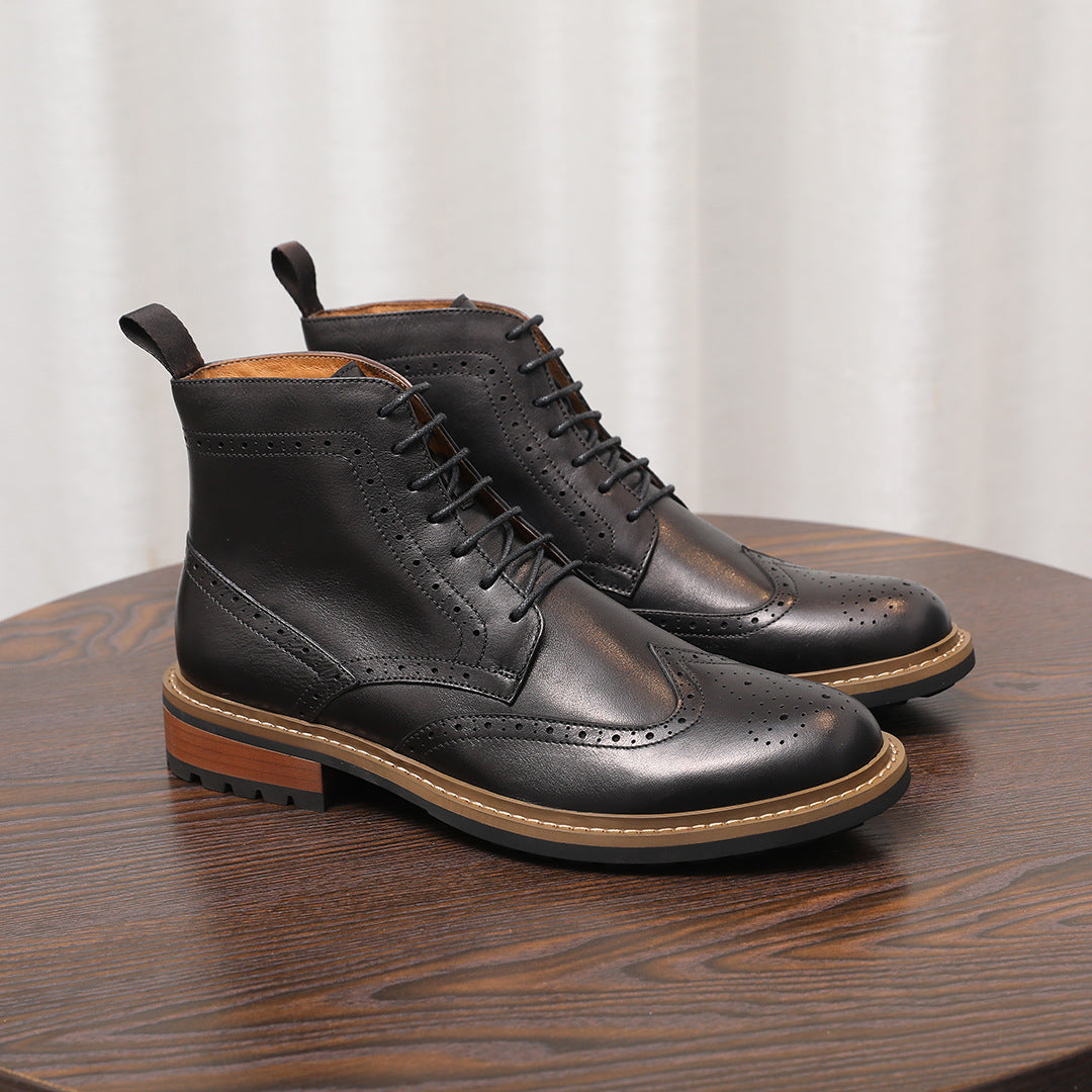 Black leather lace-up chukka boots with perforated toe and thick sole