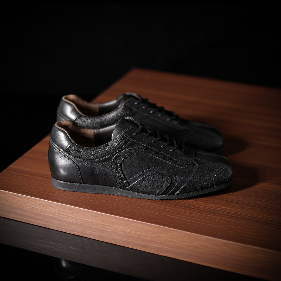 Men's black leather sneakers with lace-up front and contrasting collar lining