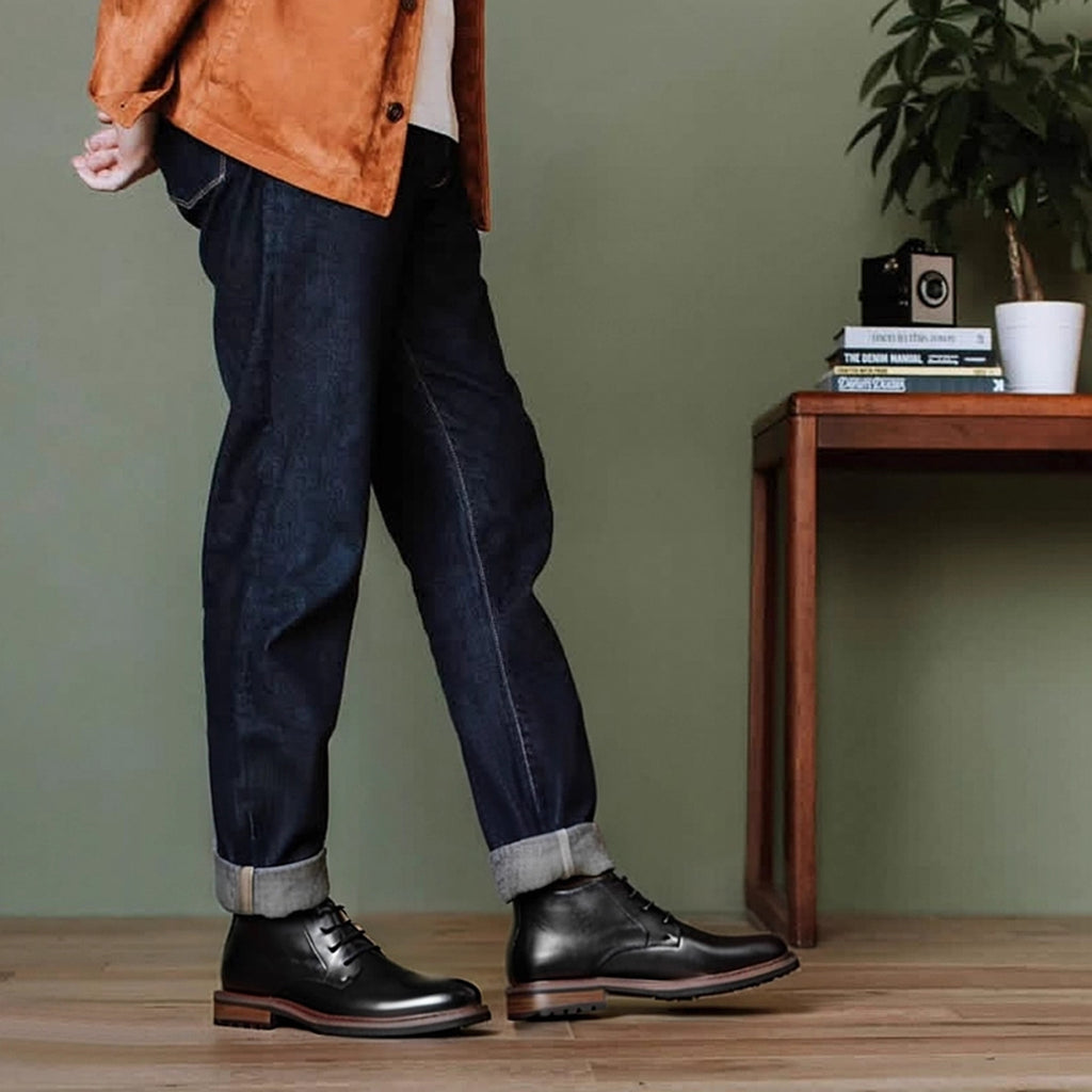 Men's black leather chukka boots with plain toe, lace-up front, and rugged sole