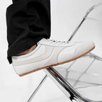 Men's white leather sneakers with lace-up front and smooth leather upper