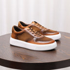 Brown minimalist leather sneakers with lace-up front and thick white platform sole