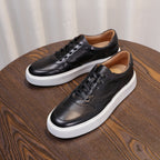 Men's leather sneakers, black, two-shoe angle view with thick white sole.