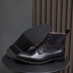 Men's dark leather lace-up ankle boot with thick sole and side pull tab