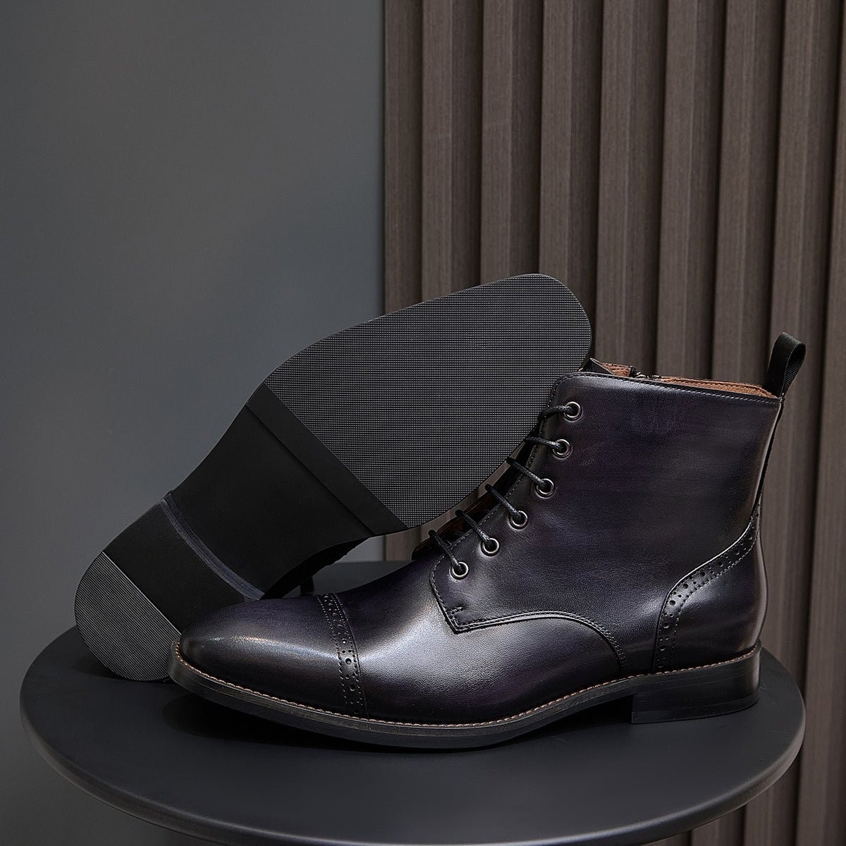 Men's dark leather lace-up ankle boot with thick sole and side pull tab