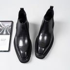Black leather Chelsea dress boots, rounded toe, perforated detailing, elastic side gore panels