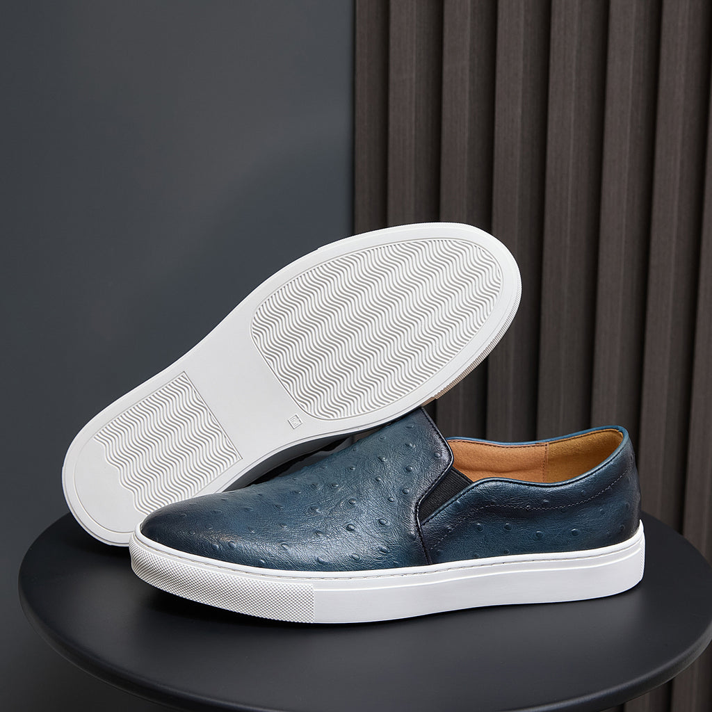 Men's sneaker outsole with tread pattern and blue leather upper, white sole edge