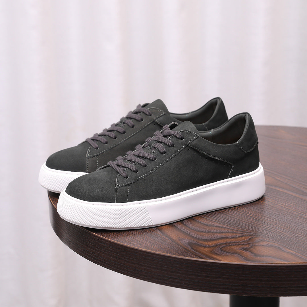 Charcoal gray leather low-top sneakers with lace-up front and white sole