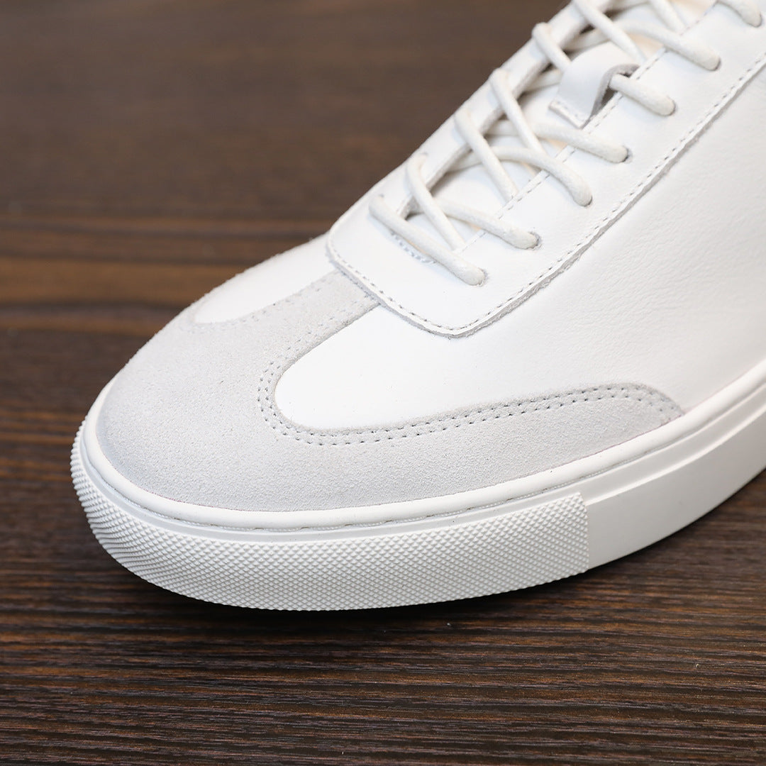 White leather sneaker toe and lace-up area with stitched detailing and textured sole edge