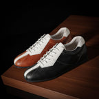 Two-tone leather sneakers: brown/white pair and black/white pair, lace-up low-top.