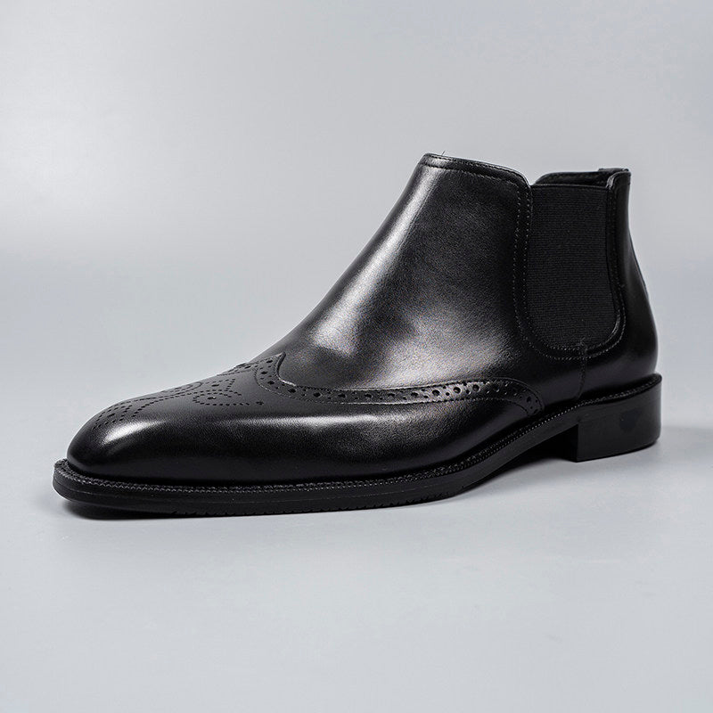 Black leather slip-on Chelsea dress boot with elastic side gore and perforated brogue detailing