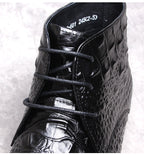 Men's black lace-up dress boot with textured upper and stitched wingtip-style detailing