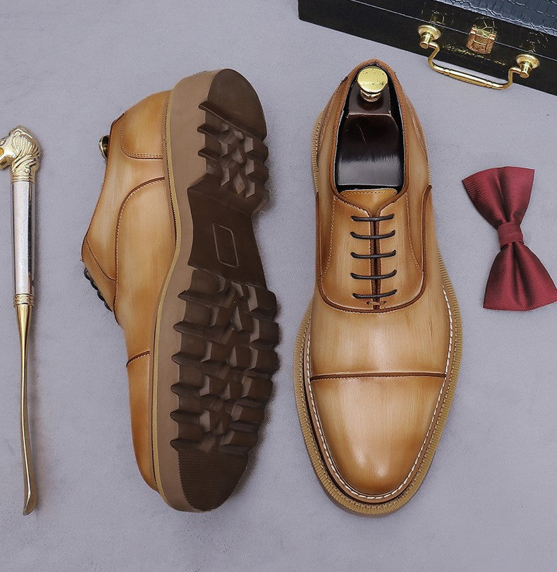 Brown/tan lace-up oxford shoes, side view, with chunky lug sole and brogue detailing.