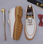 Men's chunky lug-sole oxfords in white, outsole and side view with brown trim