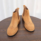 Pair of brown suede Chelsea dress boots with pointed toe and elastic ankle panels