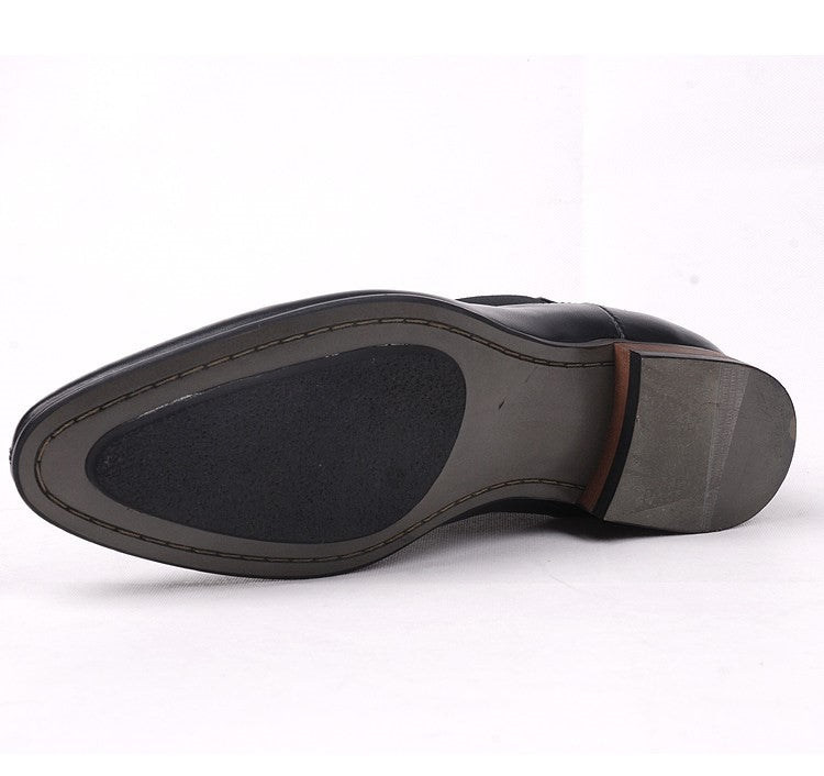 Side view of black Chelsea boot showing treaded sole and heel edge.
