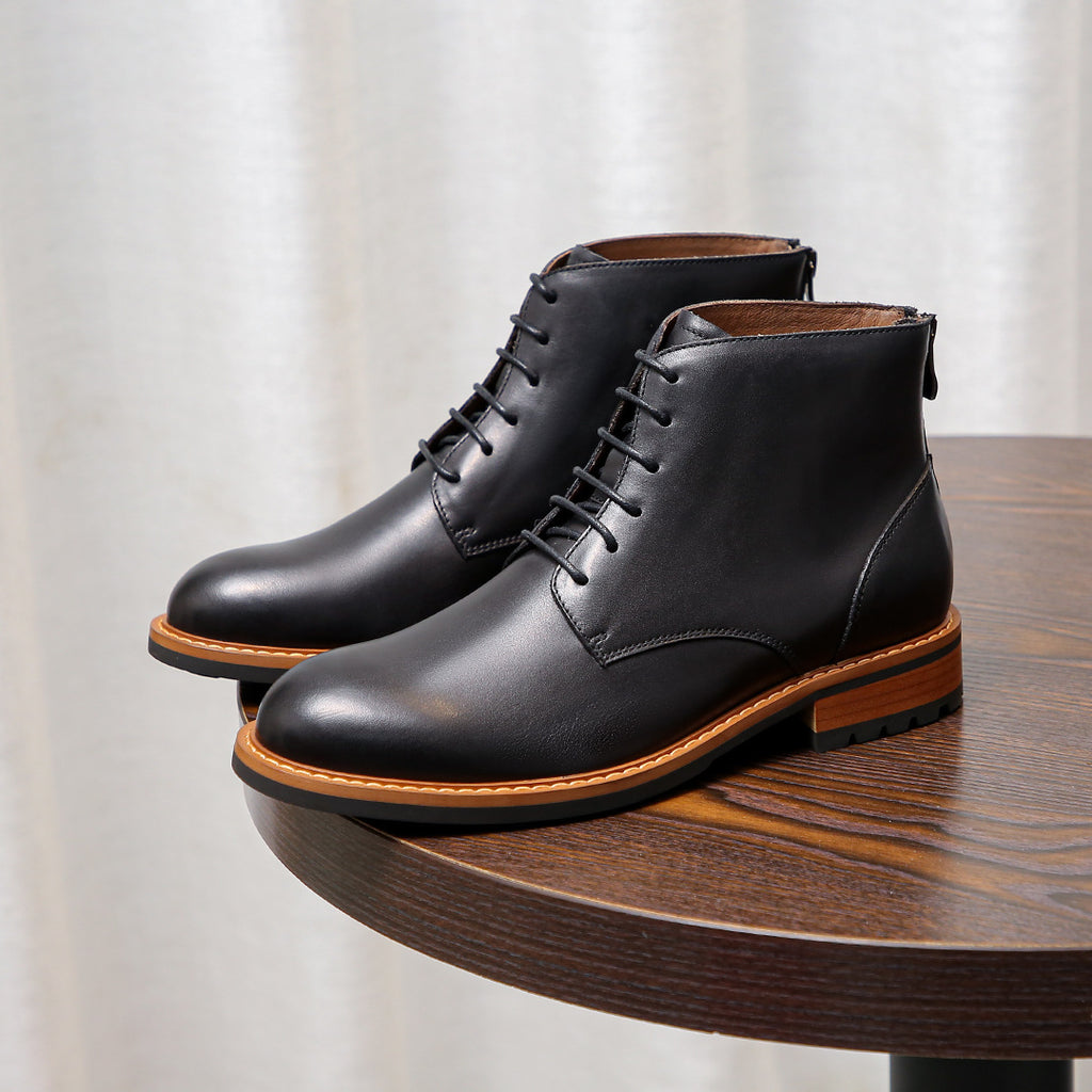 Black leather lace-up ankle boots with pointed toe and orange welt trim
