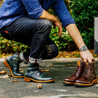 Men's dark green leather ankle dress boots with lace-up and side-zip, on person outdoors.