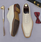 Beige and brown chunky lug-sole brogue Oxford shoes, showing outsole tread and lace-up