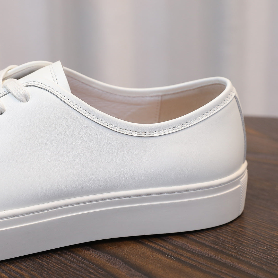 Men's leather sneakers, white leather upper detail with stitched collar and lace eyelets.