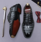 Men's black wingtip brogue oxford shoes, showing side profile and lace-up design