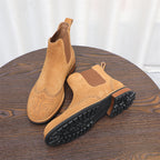 Brown suede Chelsea boots shown with treaded rubber outsole and cushioned midsole