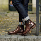 Dark brown leather pointed-toe ankle boots with side zipper and stacked sole