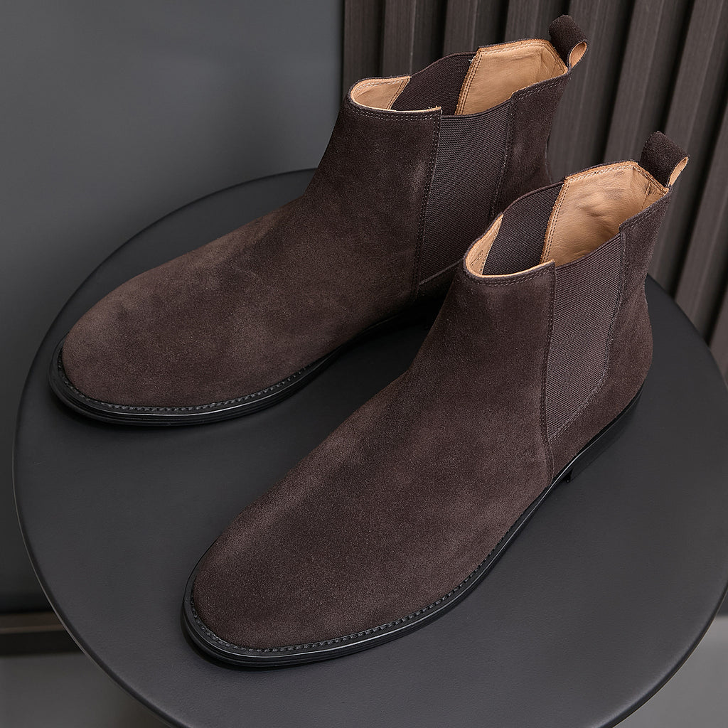 Men's pointed-toe suede Chelsea dress boots, dark brown pair on display