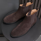 Men's pointed-toe suede Chelsea dress boots, dark brown pair on display