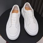 White genuine leather sneakers with lace-up closure, padded heel, and white rubber sole
