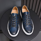 Navy leather lace-up sneakers with tan lining and white rubber sole