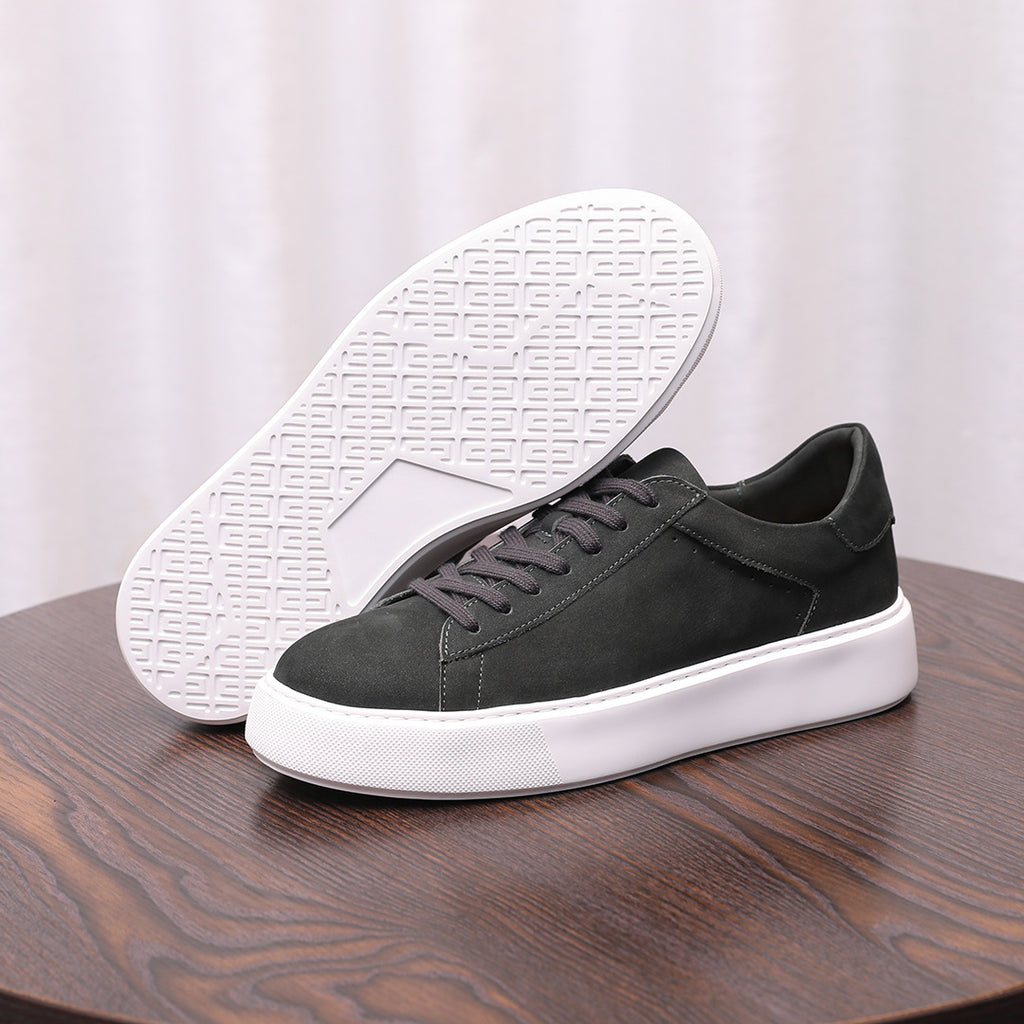 Charcoal gray leather sneakers with textured sole visible, lace-up style